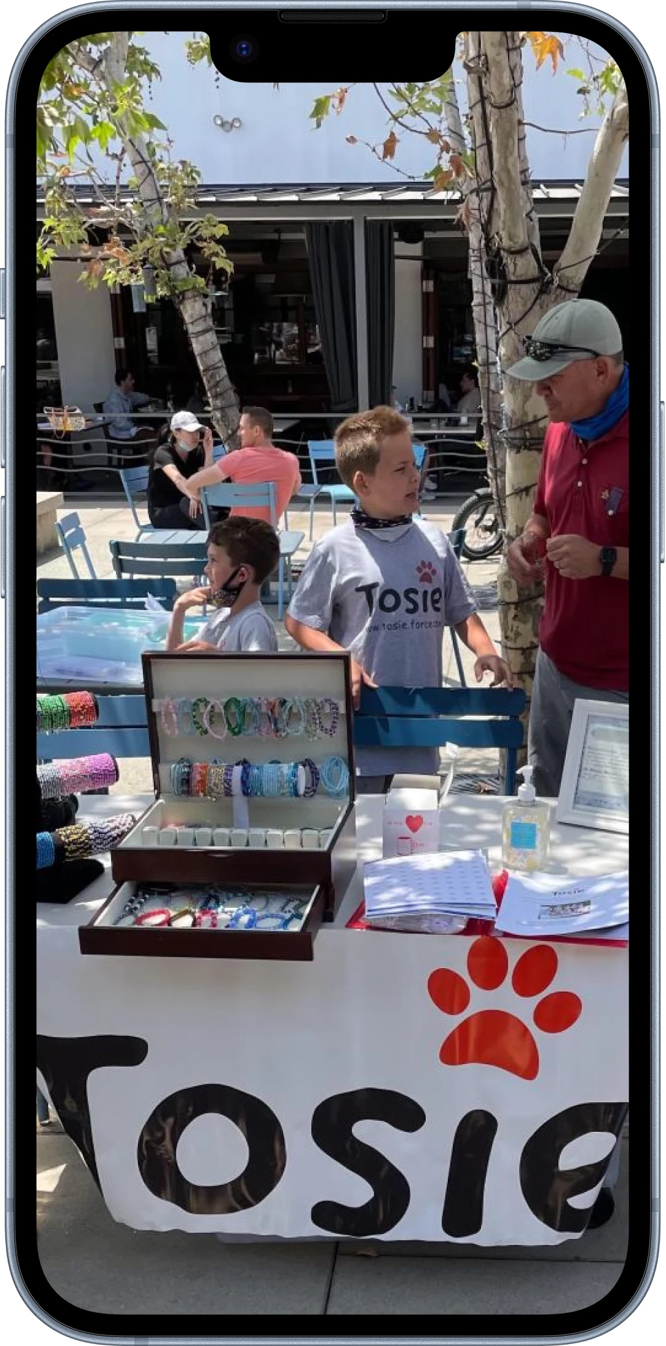 The first sale, the table under the hand painted Tosie banner with the red paw print across the front